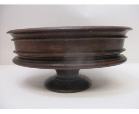 A George III mahogany table top planter of ovoid form with a rolled lip and moulded edge, on a pedestal foot with a copper li