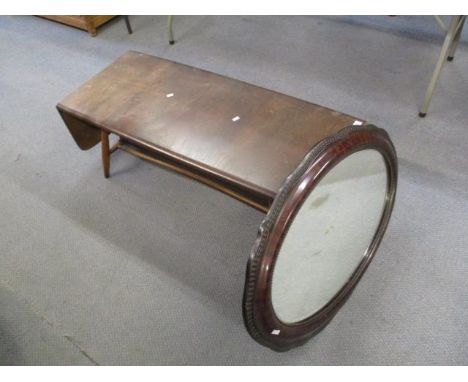 An Ercol style coffee table with extendable sides and an oval mirror, 14"h x 42"w x 18"d unextended 