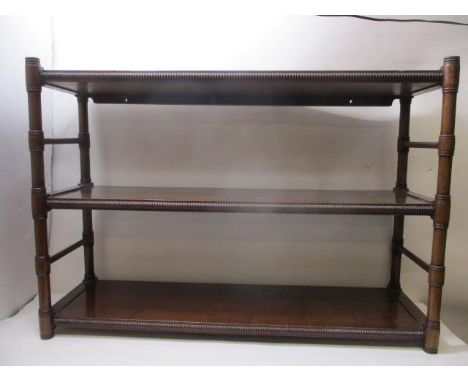 An early 19th century  mahogany, three tier shelf with carved edges and ring turned supports, 21" h, 30 3/4" w, 9"d 