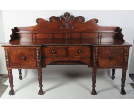 A large William IV period mahogany Sideboard, the shaped high back with carved plumage and scrolls, and with top shelf, over 