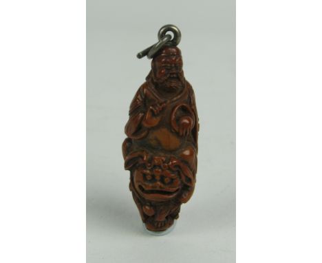 A finely carved early 19th Century Oriental wooden Netsuke type Figure of Sage, seated on the back of Fu dog. (1)