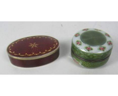 A good quality small oval enamelled silver Pill Box, the rich crimson red ground with gold border and decoration, stamped, an