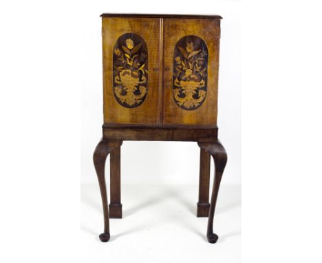 A very attractive early 19th Century marquetry Cabinet on Stand, in the George I style, the moulded top over two doors, each 