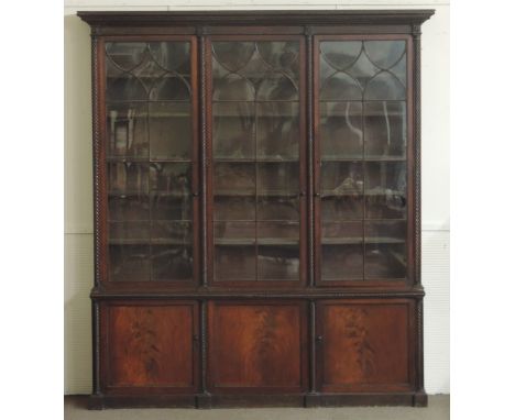 An extremely fine Irish Nelson period Bookcase, with rope turned and moulded cornice over three large astragal glazed doors f