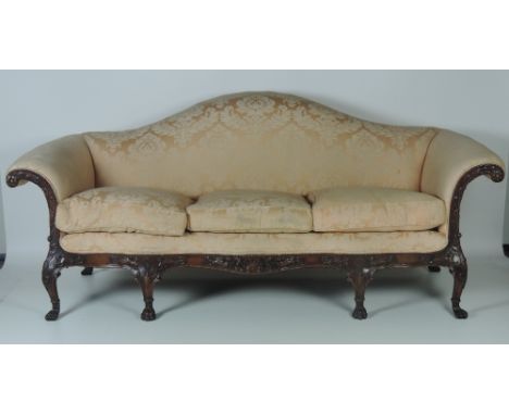 A fine carved mahogany Sofa, of George II style with stuffed hump back and out scrolled down swept arms over a serpentine fro