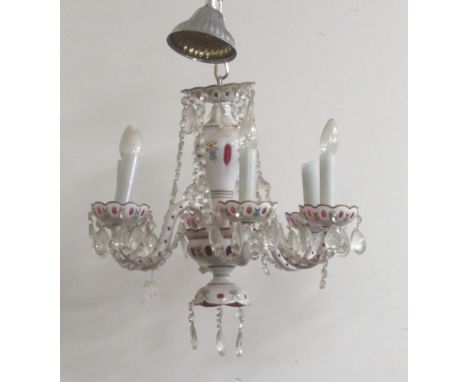 A single tier six branch coloured ruby glass Chandelier, decorated with cutglass drops and droplets, and decorated with garla