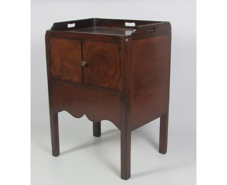A good 19th Century Georgian style mahogany Bedside Pot Cupboard, with pierced tray type top, over two inlaid panel doors, on