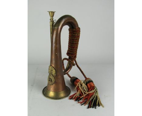 Militaria: A brass Army Bugle, with an applied badge for "Royal Welsh Fusiliers," and with colourful ribbons and tassel. (1)