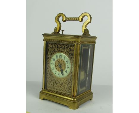 A good quality late 19th Century brass Repeater Carriage Clock, with engraved and pierced brass face with circular enamel dia