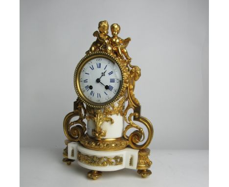 A fine 19th Century French ormolu mounted white marble Mantle Clock, by La Garde, Paris, the top surmounted by cupids etc., r
