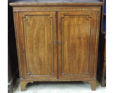 A good quality mahogany Georgian period Rug Cabinet, the moulded top over two figured panel doors with ebony string inlay, on