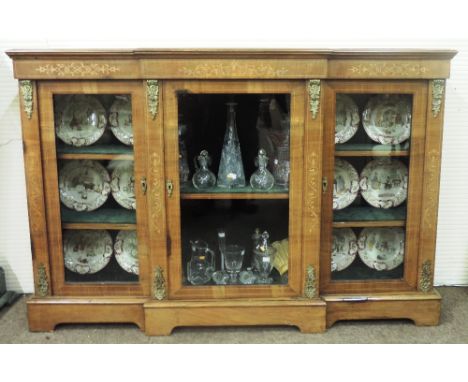 An attractive Victorian inlaid mahogany breakfront Credenza, with three glazed doors, ormolu mounts on plinth base, bracket f