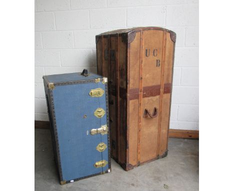 A late 19th Century tall leather bound canvas Trunk Wardrobe, with latted supports and heavy brass mounts, the interior fitte