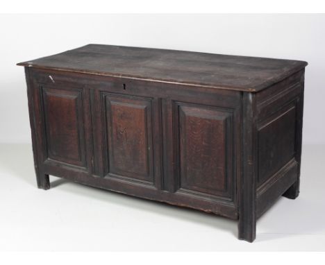 An 18th Century carved oak Coffer, the three plank lift top over panelled sides, the centre front panel with initials 'M.S.' 