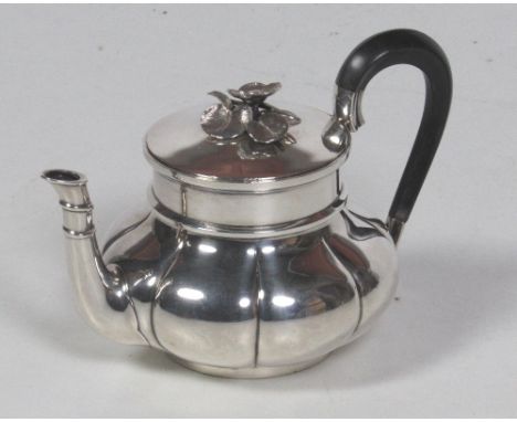 An attractive small melon shaped Continental silver Teapot, with ebony handle, and with floral finial handle on lid, approx. 