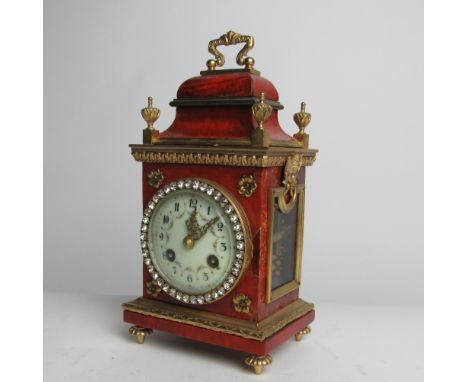 An attractive small late 19th Century French Bracket Clock, the figured body profusely decorated with ormolu mounts, the pain