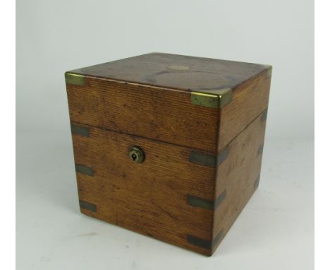 From Dromoland CastleA very good 19th Century brass bound oak Decanter Box, by J.T. Needs, Piccadilly, 20cms square, and with