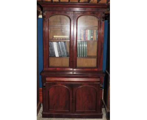 A good quality Victorian figured mahogany two door Bookcase, with frieze drawer over two panel doors on plinth base, 226cms (