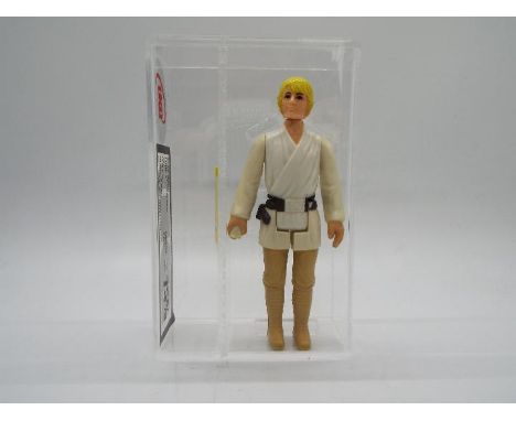 Star Wars - A loose vintage and graded Star Wars 'A New Hope' 3 3/4 action figure 'Luke Skywalker - Farmboy' Raised Bar 'Chin