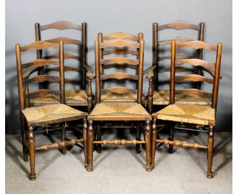 A set of six late 19th/early 20th Century elm ladder back chairs by S. Hearn (including two armchairs) with rush seats, on tu