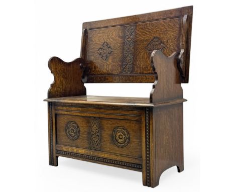 Early 20th century oak Jacobean Revival hall or monk's bench, moulded rectangular hinged top over box seat, panelled front de