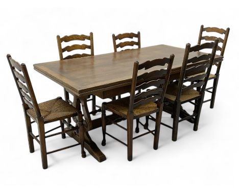 Oak extending refectory dining table, rectangular top with pull-out action leaves, shaped and scroll carved end supports on s