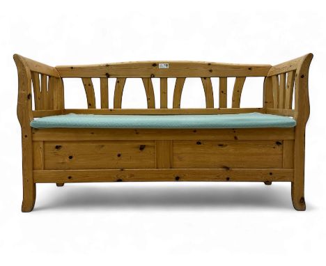 Early 20th century pine box bench, with slatted backrest and arms, hinged seat upholstered in green patterned fabric, opening