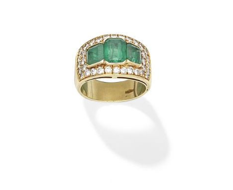 EMERALD AND DIAMOND RINGSet with a trio of step-cut emeralds, within a surround of pavé-set brilliant-cut diamonds,  ring siz