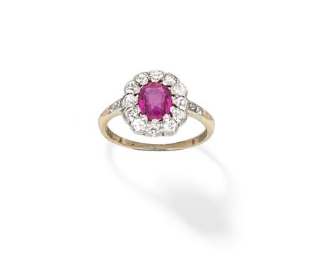 RUBY AND DIAMOND CLUSTER RINGThe oval-cut ruby within a cushion-shaped diamond surround, between similarly-set shoulders,  ri