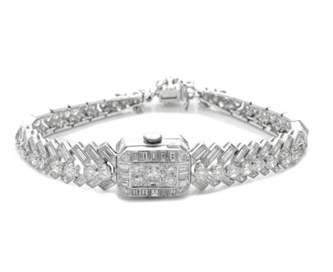 DIAMOND WATCH/BRACELETThe octagonal dial with Arabic numerals, concealed beneath a brilliant and step-cut diamond case, on a 