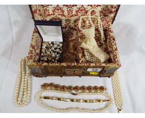 An unusual good quality jewellery box in the form of a wooden chest containing a collection of good quality costume jewellery