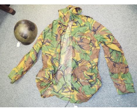 An American (US) military combat helmet, leather lining marked CCL 7 1/4 1956 and a military camaflage smock, size L - (2)