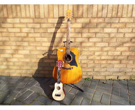 A vintage six string acoustic guitar and a Play-On miniature guitar (2)