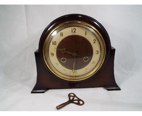 An oak cased mantle clock marked Anvil with key