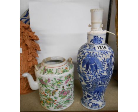 An antique Chinese porcelain vase with hand painted decoration in blue depicting a sinewy dragon amidst foliage - blue painte