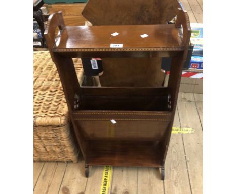 An Edwardian mahogany and strung freestanding book trough with shelf to top and undertier, set on pierced standard ends