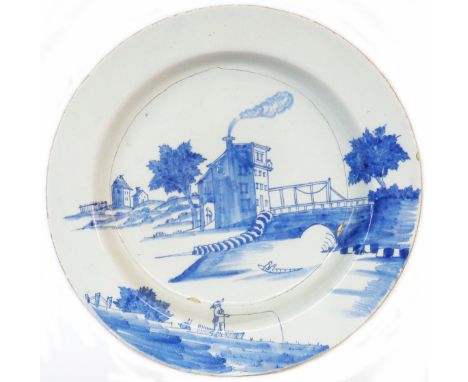 A large 18th Century Delftware charger with blue and white decoration depicting an unusual scene, the central tower house wit