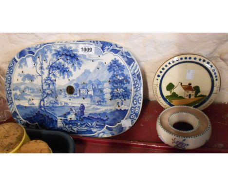 A 19th Century blue and white transfer printed strainer with a scene depicting a country house amidst landscape with heart an