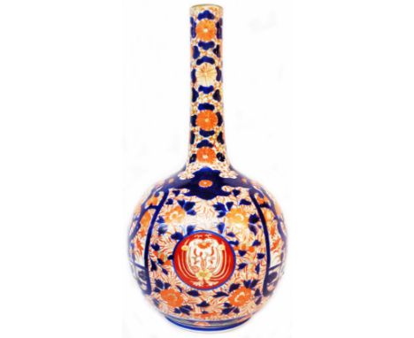 A large 19th Century Japanese Imari vase of globe bottle form with typical hand painted decoration in iron red, cobalt blue a