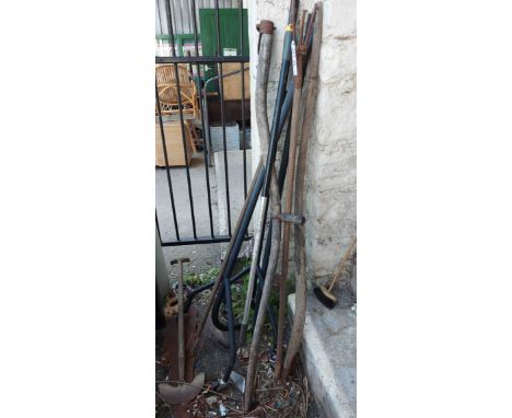 A quantity of assorted gardening tools including scythe, etc.