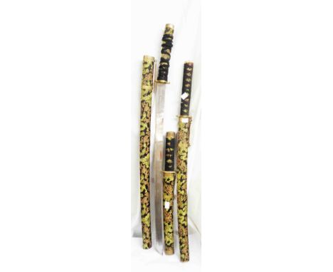 A set of three vintage decorative Japanese graduated swords with machine embroidered scabbards and handles