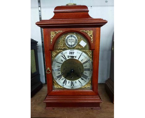 A reproduction mahogany cased bracket clock with arched dial marked for E.J. Goodfellow, Wadebridge, with Urgos floating esca