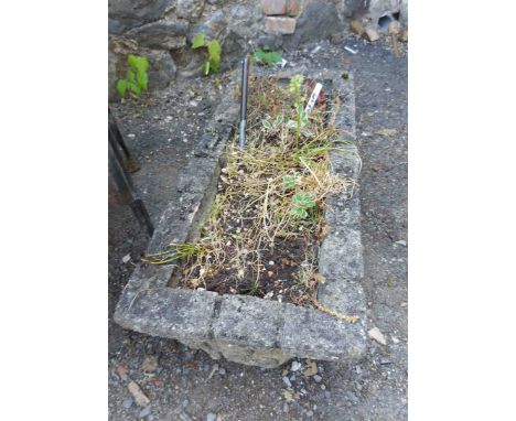A 74cm oblong concrete garden planter with coloured textured sides