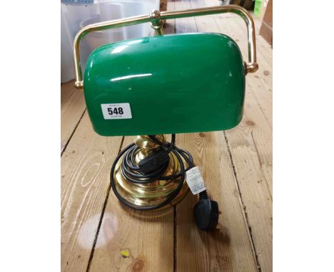 A modern banker's style lamp with brass effect finish and green glass shade