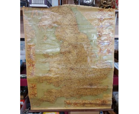 A vintage roll-up canvas backed road map of England and Wales on wooden mounts