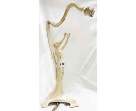 A W.M.F. Art Nouveau period silver plated pewter table lamp depicting a lady reaching skyward, the bulb holder set on whiplas