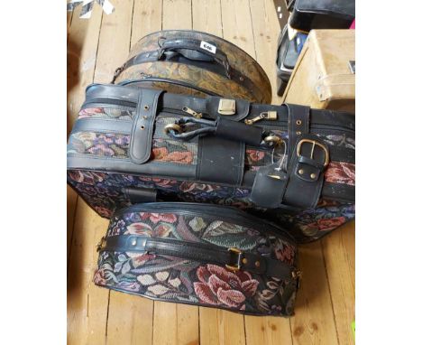 Three Carlton International suitcases with decorative tapestry finish