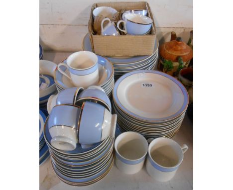 A quantity of Royal Doulton tea and dinner ware in the Regency Gold pattern including cups and saucers, plates, cereal bowls,