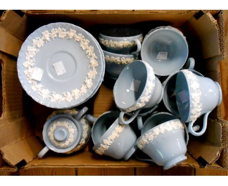 A box containing a Wedgwood part tea set in the Embossed Queensware pattern comprising cups and saucers and a sucrier