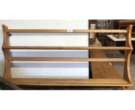 A 96cm Ercol light elm wall mounted two shelf open plate rack with shaped sides